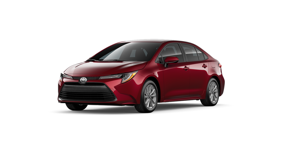 2026 Toyota Corolla LE in Ruby Flare Pearl — front three-quarter view
